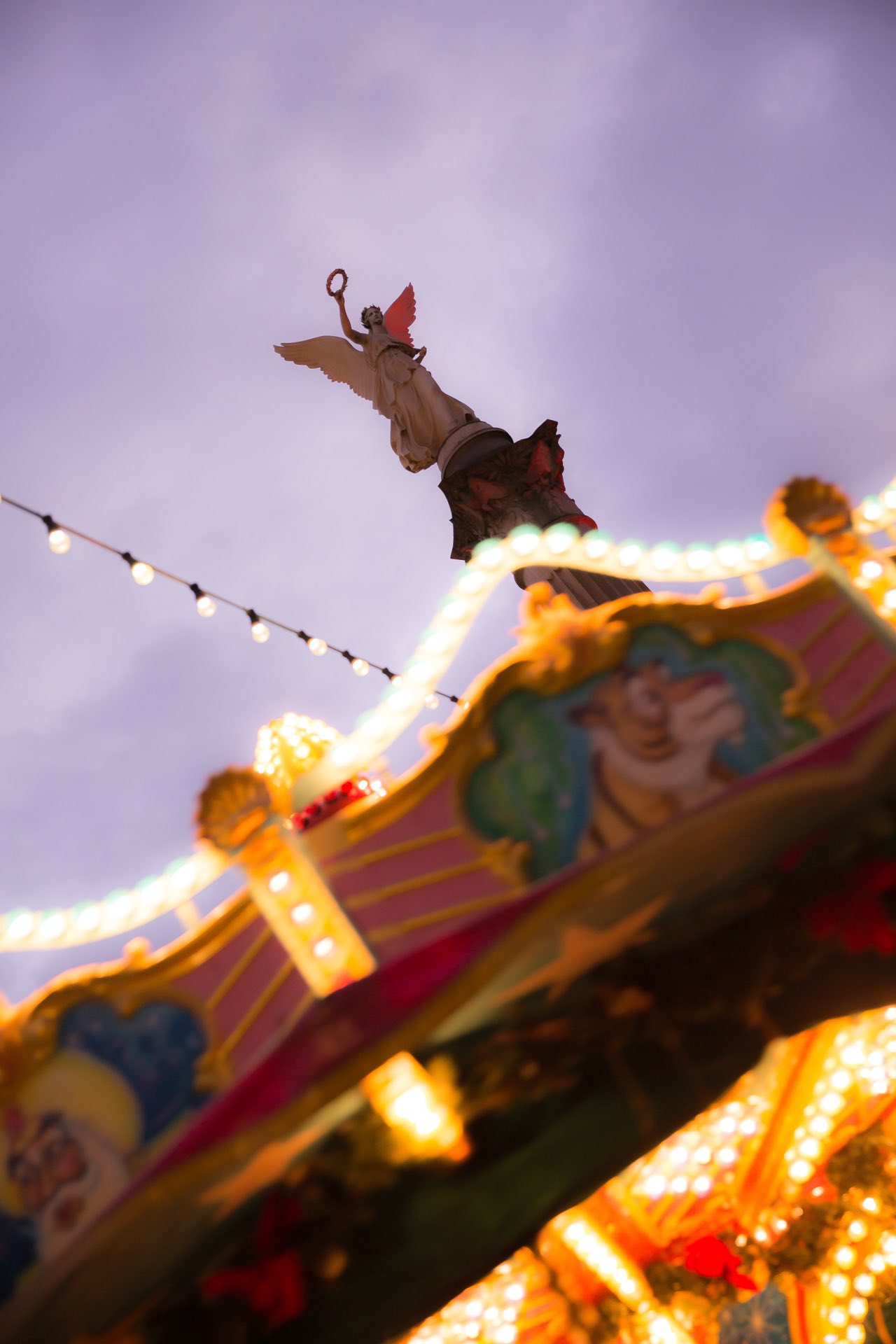 Karussell mit Engelsfigur in der Abenddämmerung